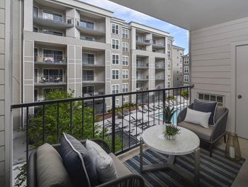 A balcony with a couch and a table